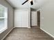 A bright bedroom featuring a closet and entry doors with wood-look flooring at 9983 Sw 188Th Cir, Dunnellon, FL 34432