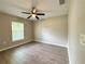 Cozy bedroom featuring a ceiling fan, neutral paint, and large picture window at 9983 Sw 188Th Cir, Dunnellon, FL 34432