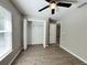 A bedroom with an open closet featuring wood-look flooring at 9983 Sw 188Th Cir, Dunnellon, FL 34432