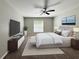 Beautiful bedroom with a ceiling fan, a large window, and a TV atop a dresser at 9983 Sw 188Th Cir, Dunnellon, FL 34432