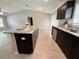 Kitchen with island featuring granite countertops and stainless steel sink at 9983 Sw 188Th Cir, Dunnellon, FL 34432
