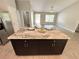 The kitchen island features granite countertops and dark cabinets, offering both style and functionality in the space at 9983 Sw 188Th Cir, Dunnellon, FL 34432
