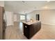 The granite kitchen island provides a focal point and functional workspace in this open-concept layout at 9983 Sw 188Th Cir, Dunnellon, FL 34432