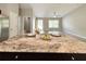 Granite countertop island between kitchen and living room, complete with wine glasses and table setting at 9983 Sw 188Th Cir, Dunnellon, FL 34432
