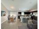 Open floor plan featuring kitchen with central island, stainless appliances, and adjacent dining area at 9983 Sw 188Th Cir, Dunnellon, FL 34432