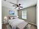 Light-filled main bedroom with ceiling fan, ensuite bathroom and neutral paint at 9983 Sw 188Th Cir, Dunnellon, FL 34432