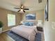 Spacious main bedroom featuring a ceiling fan, neutral paint, and large picture window at 9983 Sw 188Th Cir, Dunnellon, FL 34432