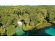 Beautiful aerial view of a clear river surrounded by lush greenery and trees at 9983 Sw 188Th Cir, Dunnellon, FL 34432