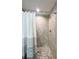 Beautiful bathroom featuring tile shower, rainfall shower head, and river rock flooring at 9983 Sw 188Th Cir, Dunnellon, FL 34432