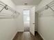 View of a walk-in closet, with wire racks, leading into a bedroom with a ceiling fan at 9983 Sw 188Th Cir, Dunnellon, FL 34432