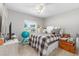 Comfortable bedroom with a window overlooking the neighborhood and a ceiling fan at 10081 Se 68Th Ct, Belleview, FL 34420