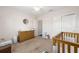 Bedroom showcasing a crib, changing table, and closet space, providing ample storage at 10081 Se 68Th Ct, Belleview, FL 34420
