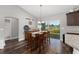 Charming dining area with wood table, chandelier lighting, and sliding door access to the outdoors at 10081 Se 68Th Ct, Belleview, FL 34420