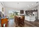 Bright dining area adjacent to the kitchen, featuring a wood table and access to the backyard at 10081 Se 68Th Ct, Belleview, FL 34420