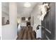 Welcoming foyer showcasing wood floors, a bench, and an open view to the kitchen and living areas at 10081 Se 68Th Ct, Belleview, FL 34420