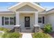 Inviting front entrance featuring stone accents, a decorative wreath, and a welcoming 'hello' mat at 10081 Se 68Th Ct, Belleview, FL 34420