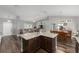 Open-concept living room and dining area with hardwood floors and vaulted ceilings at 10081 Se 68Th Ct, Belleview, FL 34420