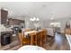 Open-concept living space with a dining area and modern kitchen under recessed lighting at 10081 Se 68Th Ct, Belleview, FL 34420