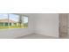 Bright bedroom featuring a large window with backyard views and double door closet for ample storage at 10556 Sw 96Th Lane Rd, Ocala, FL 34481