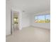 Bright bedroom featuring a large window with views of the neighborhood and light tile flooring at 10556 Sw 96Th Lane Rd, Ocala, FL 34481