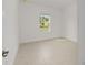 Bright bedroom featuring light tile flooring and a window with neighborhood views at 10556 Sw 96Th Lane Rd, Ocala, FL 34481