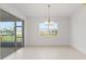 Dining room featuring chandelier, large windows for natural light, and adjacent patio access at 10556 Sw 96Th Lane Rd, Ocala, FL 34481