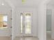 Bright entryway with tile flooring, featuring a decorative glass front door and neutral wall paint at 10556 Sw 96Th Lane Rd, Ocala, FL 34481
