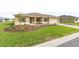 Attractive single-story home featuring a well-kept lawn, complemented by a paver driveway and a two-car garage at 10556 Sw 96Th Lane Rd, Ocala, FL 34481