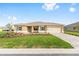 Inviting single-story home showcasing a lush lawn, a paver driveway, and a convenient two-car garage at 10556 Sw 96Th Lane Rd, Ocala, FL 34481