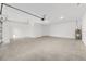 Spacious garage featuring concrete flooring, an overhead door, and ample room for storage at 10556 Sw 96Th Lane Rd, Ocala, FL 34481