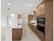 Modern kitchen with stainless steel appliances, ample cabinets, and a large island with a sink at 10556 Sw 96Th Lane Rd, Ocala, FL 34481