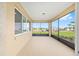 The screened lanai with concrete flooring offers pleasant views of the neighborhood at 10556 Sw 96Th Lane Rd, Ocala, FL 34481