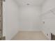 This laundry room is complete with a wire shelf, tile floors, and a utility sink at 10556 Sw 96Th Lane Rd, Ocala, FL 34481