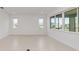 Bright, open living room with neutral tile floors, recessed lighting, and large windows at 10556 Sw 96Th Lane Rd, Ocala, FL 34481