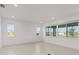 Bright, airy living room with large windows, tile floors, and neutral color palette at 10556 Sw 96Th Lane Rd, Ocala, FL 34481