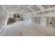 Unfinished attic with bright natural light, plasterboard walls, and a single window at 11806 Sw 61St Place Rd, Ocala, FL 34481
