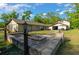 Beautiful backyard includes a stone fire pit, covered seating area, and lush greenery at 11806 Sw 61St Place Rd, Ocala, FL 34481