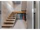 Unfinished basement with wooden stairs, cinder block walls, and utility equipment in view at 11806 Sw 61St Place Rd, Ocala, FL 34481