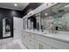 Elegant bathroom featuring double sinks, marble countertops, and a large mirror at 11806 Sw 61St Place Rd, Ocala, FL 34481