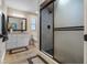 Modern bathroom showcasing sleek vanity, elegant lighting, and enclosed shower with tiled walls at 11806 Sw 61St Place Rd, Ocala, FL 34481