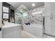 Luxurious bathroom with a soaking tub, glass shower, and elegant fixtures at 11806 Sw 61St Place Rd, Ocala, FL 34481
