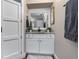 Cozy bathroom featuring a granite vanity, white cabinets and a sliding barn door at 11806 Sw 61St Place Rd, Ocala, FL 34481