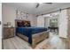 Comfortable bedroom with wood-look flooring, wooden furniture and a barn door leading to another room at 11806 Sw 61St Place Rd, Ocala, FL 34481