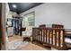 Bedroom with a crib, rocking chair, and closet storage at 11806 Sw 61St Place Rd, Ocala, FL 34481