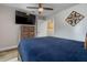 Cozy bedroom with accent wall, wood-look flooring and a television provides an abundance of space at 11806 Sw 61St Place Rd, Ocala, FL 34481