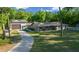 Charming home with a long driveway, front porch, and separate garage at 11806 Sw 61St Place Rd, Ocala, FL 34481