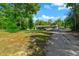 Ranch-style home with light gray exterior and a sprawling front lawn surrounded by mature trees and natural landscape at 11806 Sw 61St Place Rd, Ocala, FL 34481