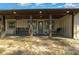 Inviting covered front porch with a swing, ceiling fan and comfortable seating at 11806 Sw 61St Place Rd, Ocala, FL 34481