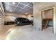 Spacious garage featuring block walls, a finished ceiling, vehicle parking and stairs to additional space at 11806 Sw 61St Place Rd, Ocala, FL 34481