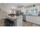 Modern kitchen featuring white cabinetry, stainless steel appliances and a kitchen island with seating at 11806 Sw 61St Place Rd, Ocala, FL 34481